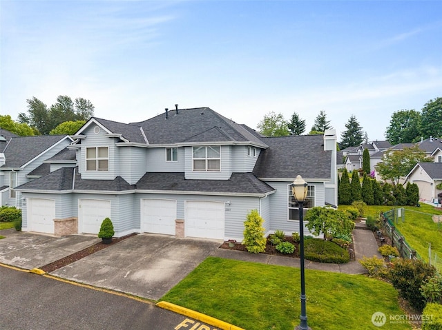 12015 SE 312th Pl Unit 7D, Auburn, WA 98092 - view of front of property featuring driveway, an attached garage, a front lawn, a shingled roof, and a chimney