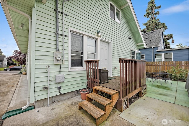 1027 S 60th St, Tacoma, WA 98408 - rear view of property with fence and a wooden deck