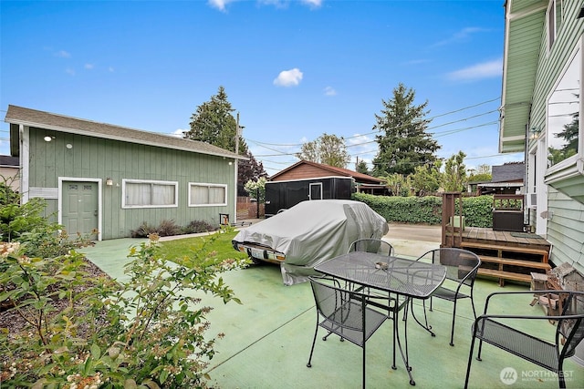 1027 S 60th St, Tacoma, WA 98408 - view of patio featuring outdoor dining space and a deck