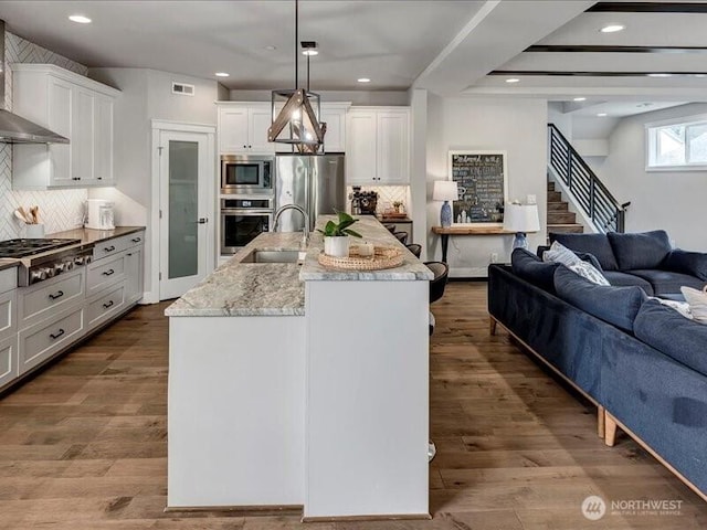11550 174th Ave NE, Redmond, WA 98052 - kitchen with stainless steel appliances, open floor plan, a sink, tasteful backsplash, and white cabinets
