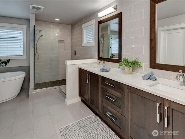 11550 174th Ave NE, Redmond, WA 98052 - full bath with a walk in shower, double vanity, tile patterned floors, and tile walls