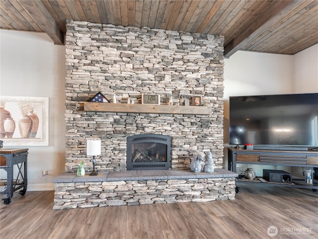 2611 Paisley St SE, East Wenatchee, WA 98802 - living area featuring wood ceiling, beamed ceiling, a fireplace, wood finished floors, and baseboards