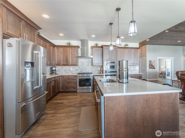 2611 Paisley St SE, East Wenatchee, WA 98802 - kitchen with stainless steel appliances, wall chimney exhaust hood, a sink, dark wood-style flooring, and light countertops