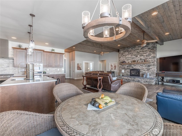 2611 Paisley St SE, East Wenatchee, WA 98802 - dining area with a fireplace, wood ceiling, dark wood-style flooring, ceiling fan, and recessed lighting