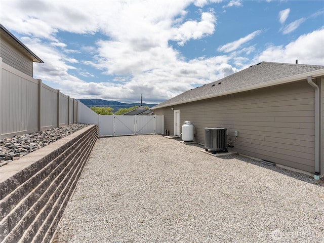 2611 Paisley St SE, East Wenatchee, WA 98802 - view of yard featuring a gate, central AC unit, and fence