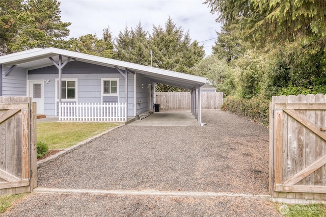 184 Frigate St NW, Ocean Shores, WA 98569 - view of parking featuring driveway and a carport