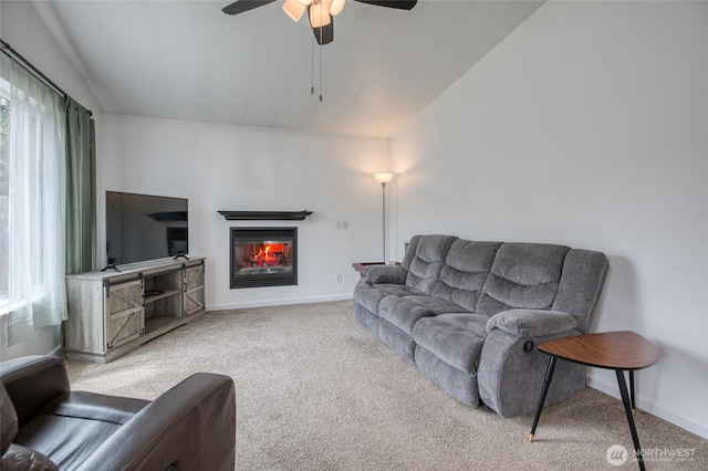 184 Frigate St NW, Ocean Shores, WA 98569 - living area with vaulted ceiling, carpet floors, a glass covered fireplace, ceiling fan, and baseboards