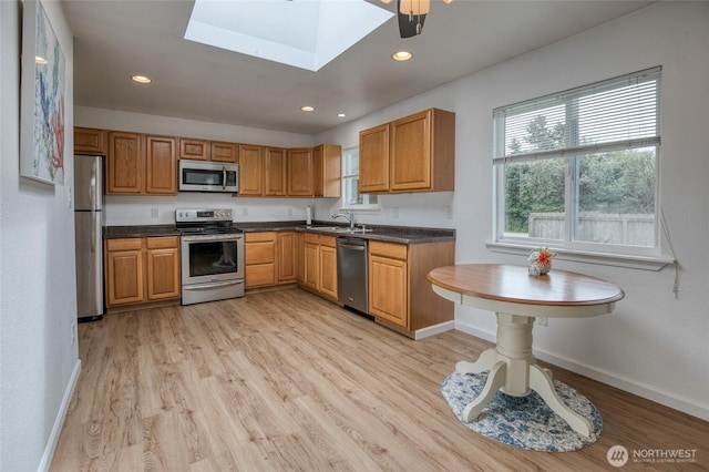 184 Frigate St NW, Ocean Shores, WA 98569 - kitchen with appliances with stainless steel finishes, baseboards, dark countertops, a sink, and recessed lighting