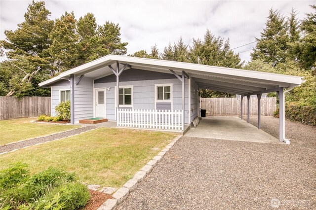 184 Frigate St NW, Ocean Shores, WA 98569 - view of front facade with a carport and gravel driveway