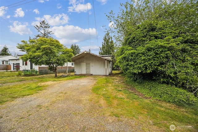 3122 Oas Dr W, University Place, WA 98466 - view of front of home featuring fence, dirt driveway, and an outbuilding
