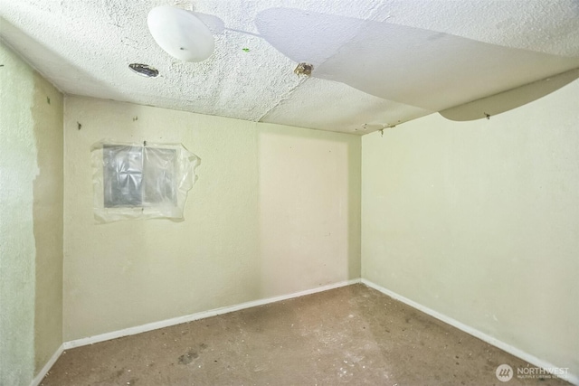 3122 Oas Dr W, University Place, WA 98466 - empty room featuring baseboards and a textured ceiling