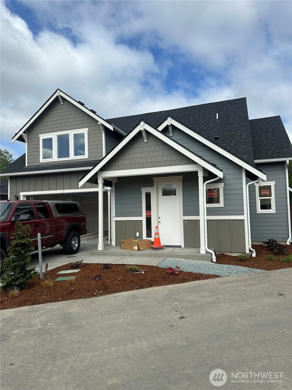 803 Parkland Loop, Sedro Woolley, WA 98284 - view of front facade with board and batten siding, roof with shingles, and a garage
