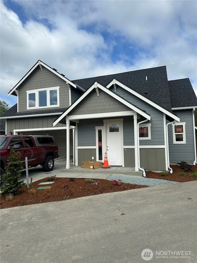 803 Parkland Loop, Sedro Woolley, WA 98284 - view of front facade with board and batten siding, roof with shingles, and a garage