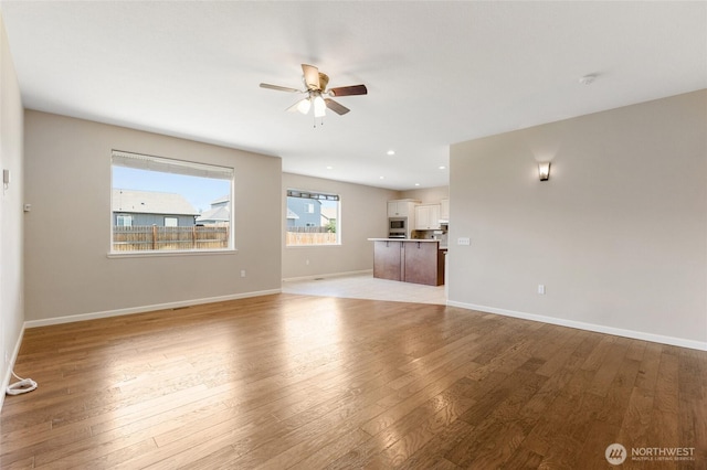 546 S Driftwood Ln, Moses Lake, WA 98837 - unfurnished living room featuring a ceiling fan, light wood finished floors, baseboards, and recessed lighting