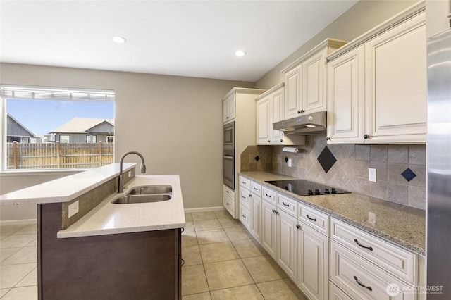 546 S Driftwood Ln, Moses Lake, WA 98837 - kitchen featuring under cabinet range hood, a sink, stainless steel appliances, light tile patterned flooring, and baseboards