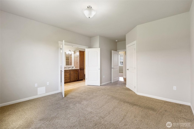 546 S Driftwood Ln, Moses Lake, WA 98837 - unfurnished bedroom featuring light colored carpet, baseboards, and connected bathroom