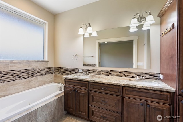 546 S Driftwood Ln, Moses Lake, WA 98837 - bathroom with a bath, double vanity, a chandelier, and tasteful backsplash