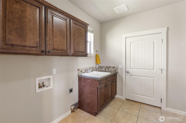546 S Driftwood Ln, Moses Lake, WA 98837 - clothes washing area with hookup for an electric dryer, cabinet space, washer hookup, baseboards, and light tile patterned floors