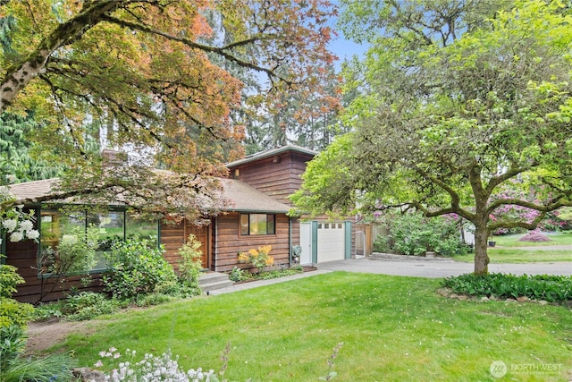 16044 33rd Ave NE, Lake Forest Park, WA 98155 - view of front of house featuring asphalt driveway, an attached garage, a front yard, and roof with shingles