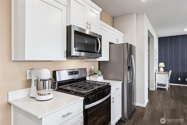 kitchen with appliances with stainless steel finishes, dark wood-type flooring, white cabinets, light countertops, and recessed lighting
