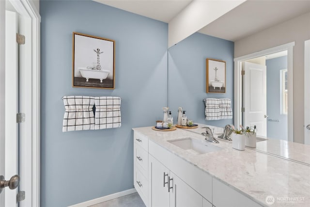 bathroom with vanity and baseboards
