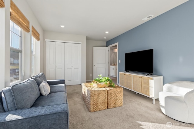 carpeted living room featuring recessed lighting and baseboards