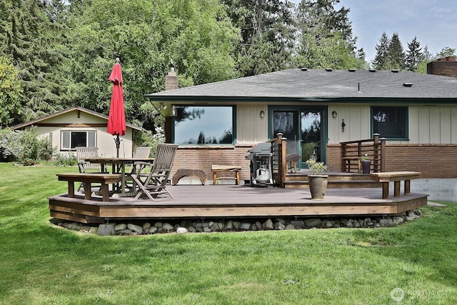 5066 Bayview Rd, Langley, WA 98260 - rear view of property with a chimney, a wooden deck, a yard, and brick siding