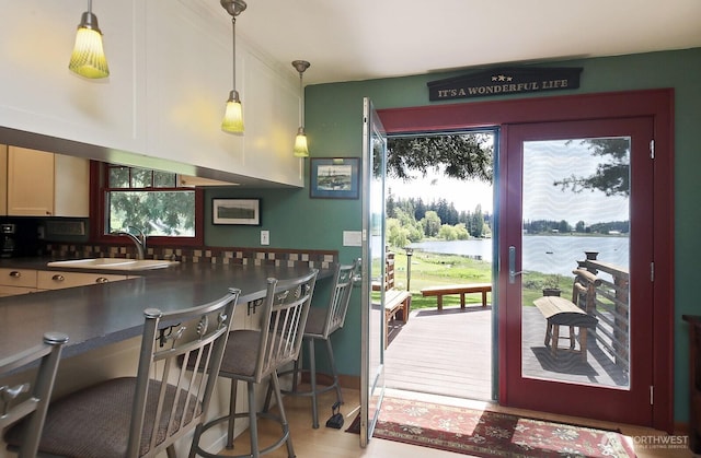 5066 Bayview Rd, Langley, WA 98260 - kitchen with a sink, a water view, pendant lighting, wood finished floors, and dark countertops
