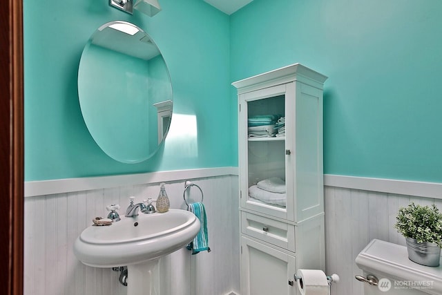 5066 Bayview Rd, Langley, WA 98260 - bathroom featuring a wainscoted wall, toilet, and a sink