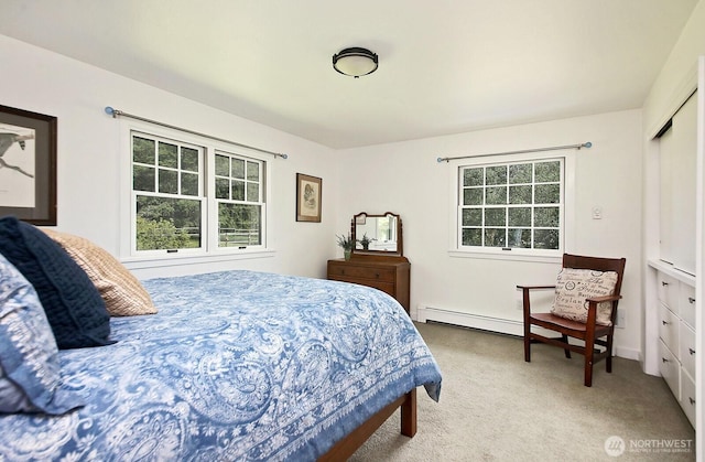 5066 Bayview Rd, Langley, WA 98260 - bedroom with light colored carpet, multiple windows, and a baseboard radiator