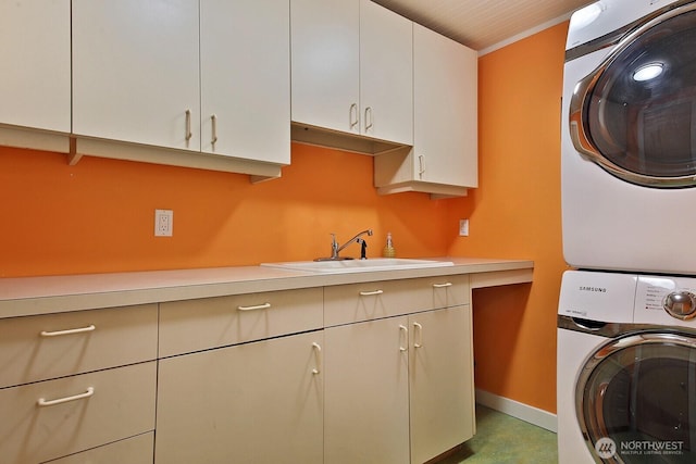 5066 Bayview Rd, Langley, WA 98260 - laundry area with stacked washer / dryer, cabinet space, and baseboards