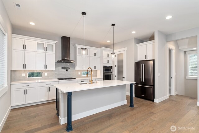 13041 75th Pl S, Seattle, WA 98178 - kitchen with high end refrigerator, wall chimney range hood, a sink, double wall oven, and gas cooktop