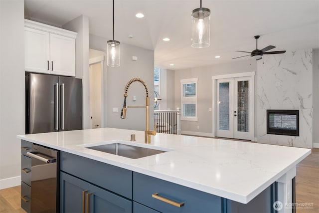13041 75th Pl S, Seattle, WA 98178 - kitchen with a sink, high end refrigerator, light wood-style floors, hanging light fixtures, and recessed lighting