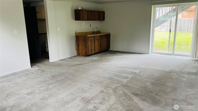 3732 S 254th Pl, Kent, WA 98032 - unfurnished living room with light carpet, a sink, and baseboards