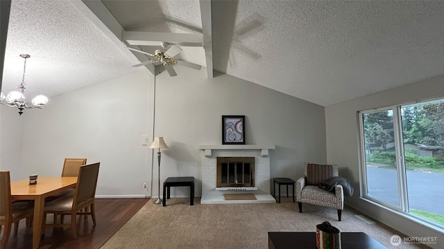 3732 S 254th Pl, Kent, WA 98032 - living room featuring a textured ceiling, a chandelier, a ceiling fan, dark wood-style flooring, and a fireplace
