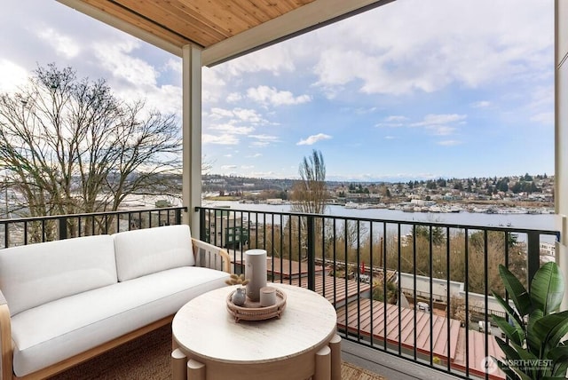 balcony featuring a water view and an outdoor hangout area