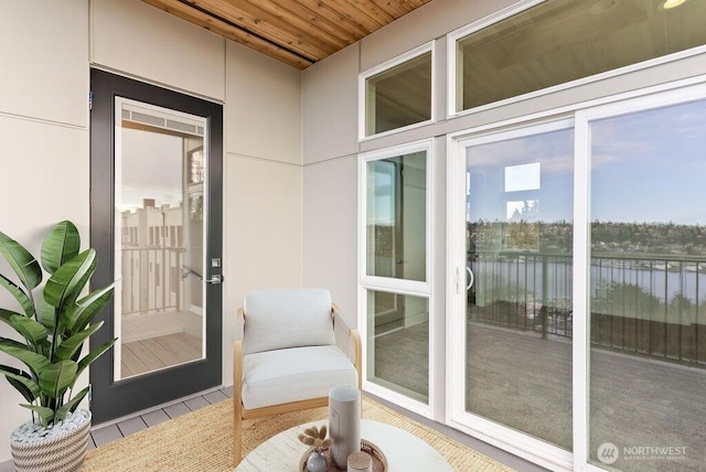 property entrance featuring a water view and stucco siding