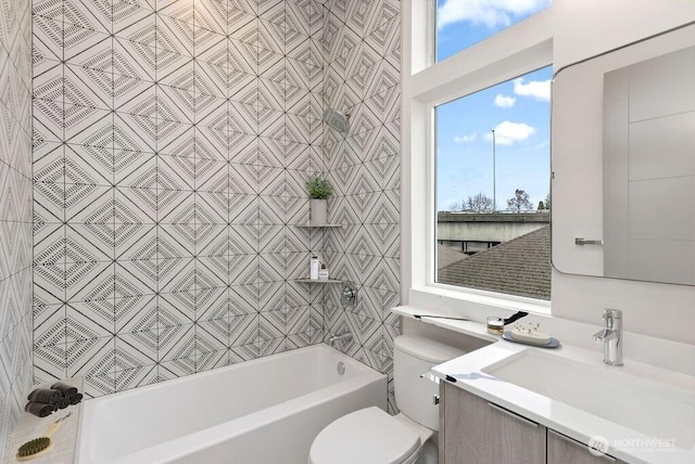 bathroom featuring toilet, vanity, and bathing tub / shower combination
