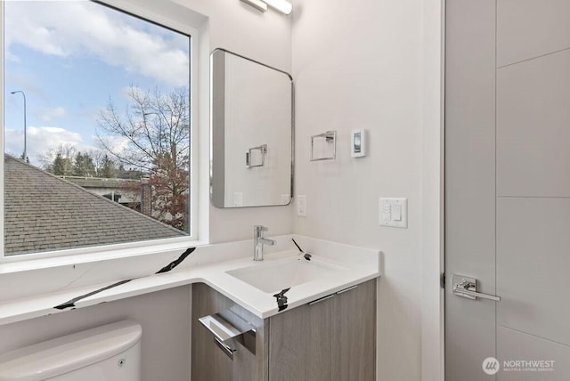 half bathroom featuring toilet and vanity