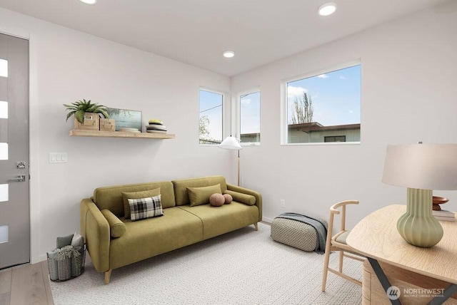 living room with healthy amount of natural light, recessed lighting, and wood finished floors