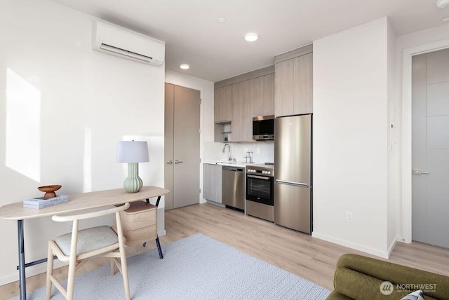 kitchen featuring appliances with stainless steel finishes, a wall mounted air conditioner, light countertops, light wood-type flooring, and recessed lighting