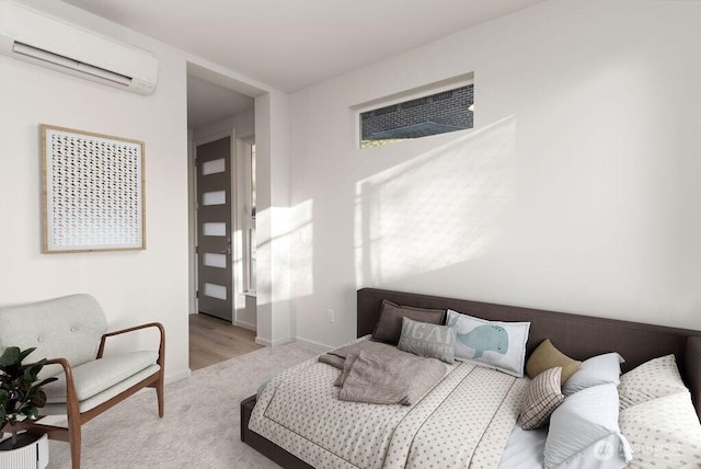 carpeted bedroom featuring a wall mounted AC and baseboards