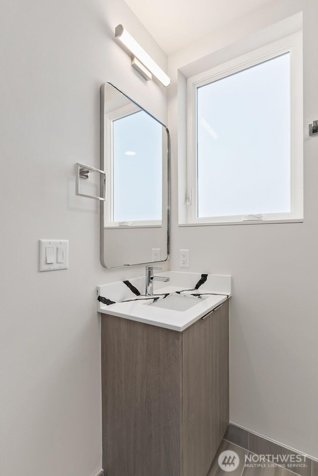 bathroom featuring baseboards and vanity
