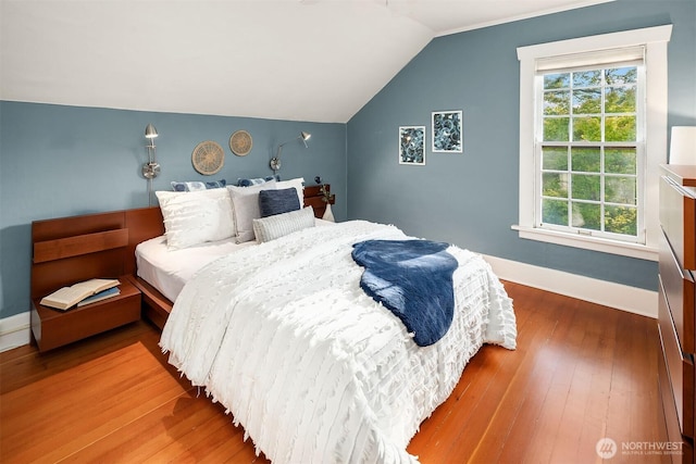 3227 37th Ave S, Seattle, WA 98144 - bedroom featuring multiple windows, vaulted ceiling, hardwood / wood-style flooring, and baseboards