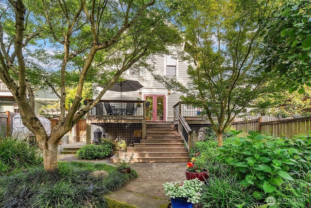 3227 37th Ave S, Seattle, WA 98144 - view of property hidden behind natural elements with a wooden deck, stairs, and french doors