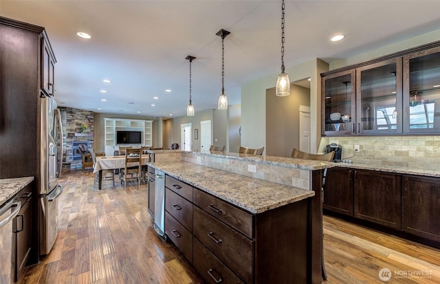 1400 Westpoint Pl, Wenatchee, WA 98801 - kitchen featuring stainless steel fridge, wood finished floors, open floor plan, dark brown cabinetry, and recessed lighting
