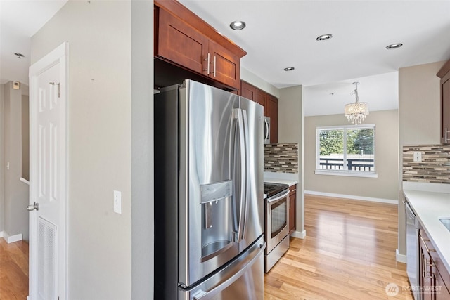 901 E Marine View Dr Unit 201, Everett, WA 98201 - kitchen featuring stainless steel appliances, light wood finished floors, backsplash, light countertops, and recessed lighting