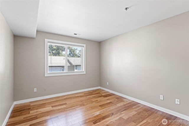 901 E Marine View Dr Unit 201, Everett, WA 98201 - empty room featuring light wood-type flooring, a pendent fire sprinkler, and baseboards