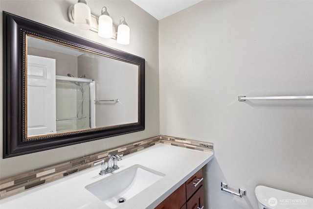 901 E Marine View Dr Unit 201, Everett, WA 98201 - bathroom featuring a stall shower, vanity, toilet, and decorative backsplash