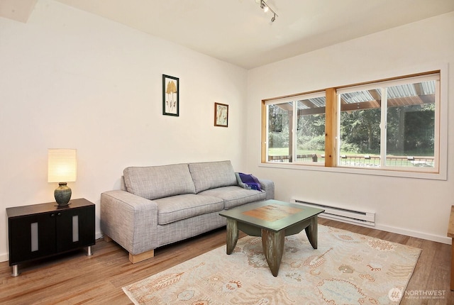 3425 Passage Way, Langley, WA 98260 - living area featuring a baseboard radiator, track lighting, and wood finished floors